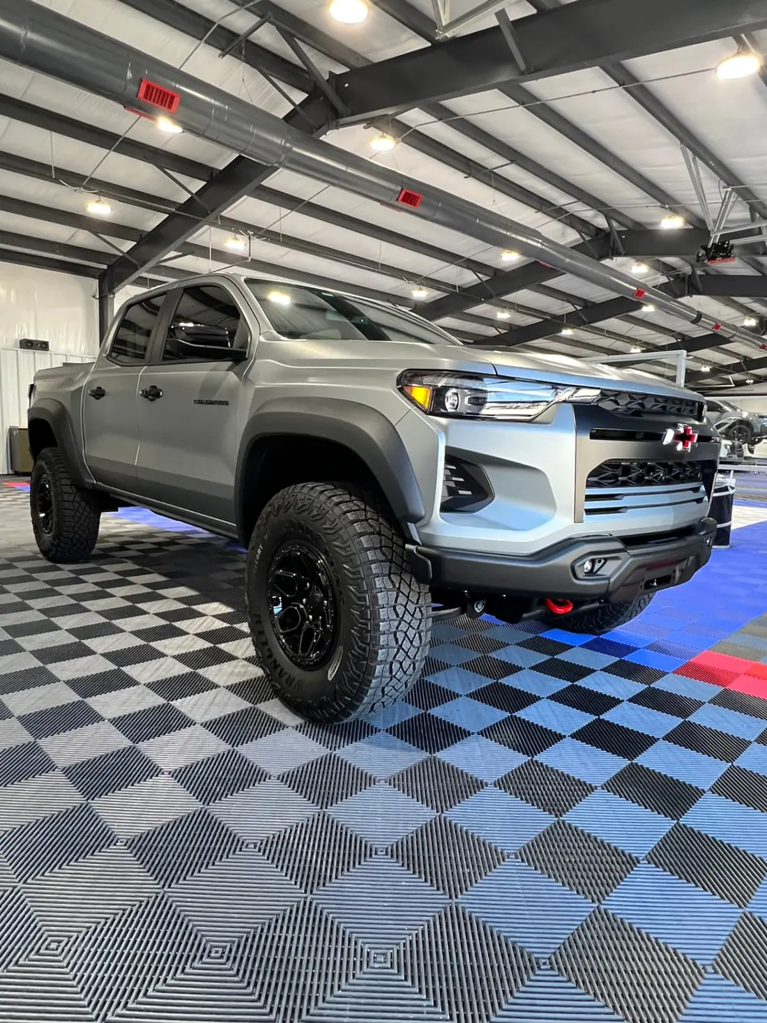 Silver Chevrolet Colorado ZR2 inside the Quality Window Tint installation bay